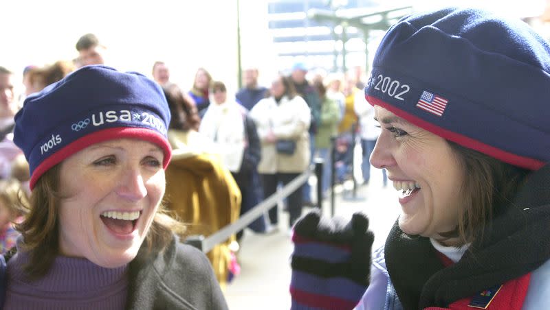 Joyce Morgan and Brenda Larsen wear the coveted Olympic team berets outside the crowded Roots store at the Gateway Center on Feb. 13, 2002. Morgan and Larsen were able to purchase the scarce berets earlier in the day. Customers began lining up as early as 6 a.m. to buy the popular head coverings.