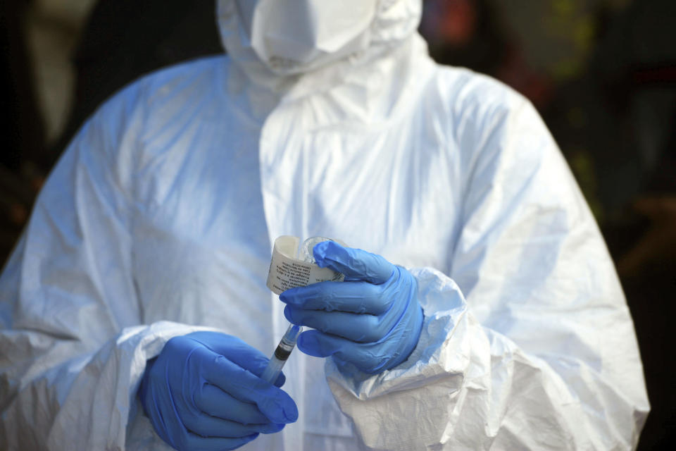 FILE - In this Wednesday, Aug. 8, 2018, file photo, a healthcare worker from the World Health Organization prepares to give an Ebola vaccination in Mangina, Democratic Republic of Congo. One-fourth of the people interviewed in eastern Congo in 2018 believed Ebola wasn’t real, according to a new study released Wednesday, March 27, 2019, underscoring the enormous challenges health care workers are now facing. (AP Photo/Al-hadji Kudra Maliro, File)