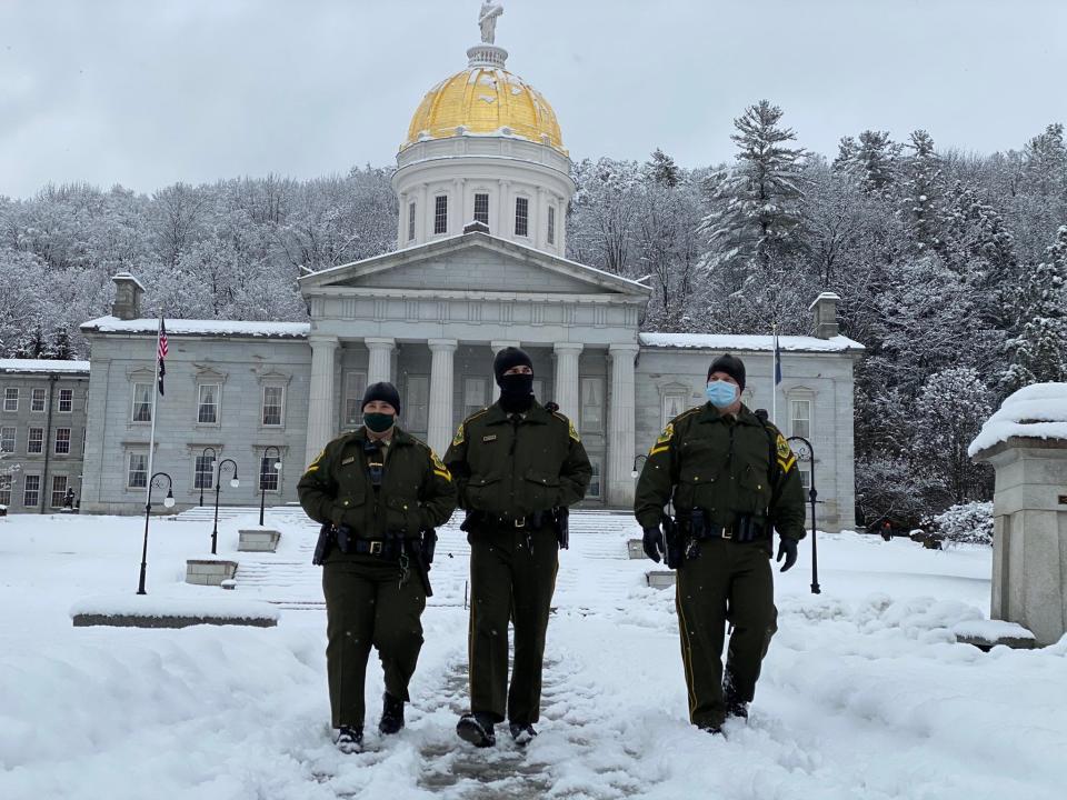 Multiple patrols of state troopers walk the Statehouse grounds in Montpelier, Vt., on Sunday, Jan. 17, 2021.