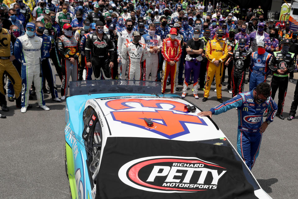 Bubba Wallace takes a moment by his car after NASCAR drivers pushed him to the front of the grid as a sign of solidarity with the driver prior to the NASCAR Cup Series GEICO 500 at Talladega Superspeedway. (Chris Graythen/Getty Images)