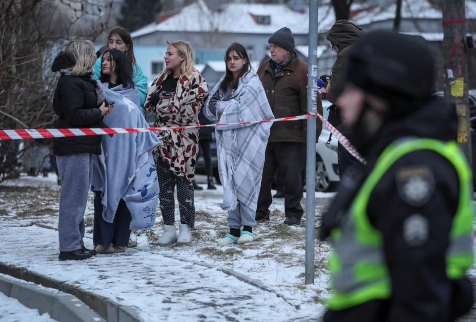 PHOTO: Local residents stand near their apartment building damaged during a Russian missile strike, amid Russia's attack on Ukraine, in Kyiv, Ukraine, Jan. 23, 2024. (Gleb Garanich/Reuters)