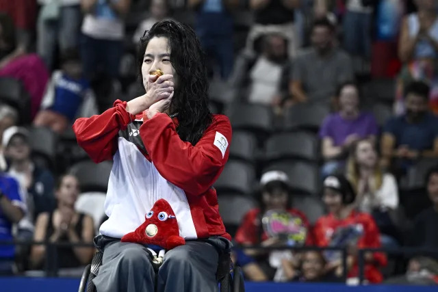 Gold medallist Singapore's swimmer Pin Xiu Yip celebrates on the podium during the medal ceremony for the Women's 50m Backstroke - S2 Gold Final at the Paris 2024 Paralympic Games, in the Paris La Defence Arena, Nanterre, west of Paris, on 31 August 2024. (Photo: JULIEN DE ROSA/AFP News)