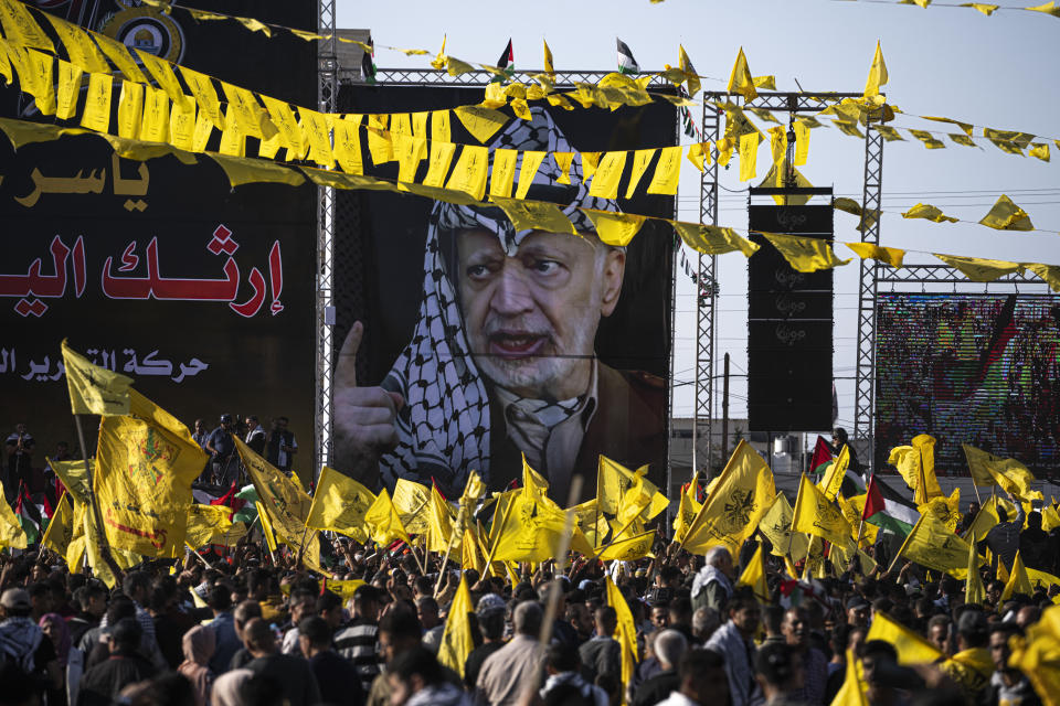 Palestinians chant slogans and wave yellow Fatah movement flags during a rally marking the 18th anniversary of the death of Fatah founder and Palestinian Authority leader Yasser Arafat in Gaza City, Thursday, Nov. 10, 2022. (AP Photo/Fatima Shbair)