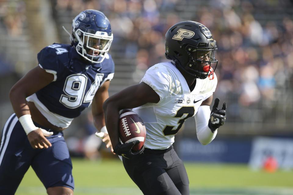 Purdue wide receiver David Bell (3) is pursued by Connecticut defensive lineman Nick Harris (94) during the first half of an NCAA football game on Saturday, Sept. 11, 2021, in East Hartford, Conn. (AP Photo/Stew Milne)