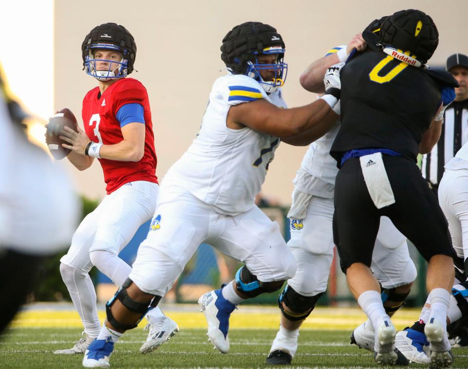 Delaware quarterback Zach Marker drops back behind protection from Bradly Anyanwu during the Blue and White Spring Game capping spring drills, Friday, April 21, 2023 at Delaware Stadium.