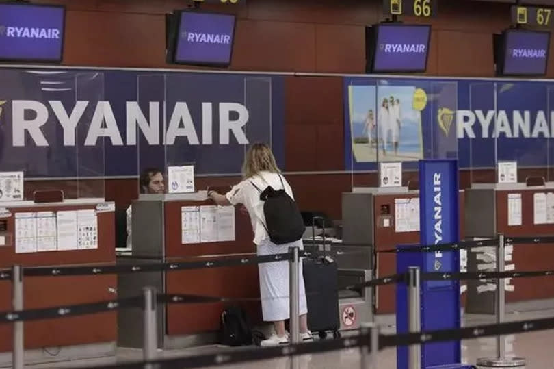 Photo shows a woman at Ryanair desk