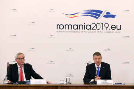 Romanian President Klaus Iohannis speaks next to European Commission President Jean-Claude Juncker in Bucharest, Romania, January 11, 2019. Inquam Photos/George Calin via REUTERS