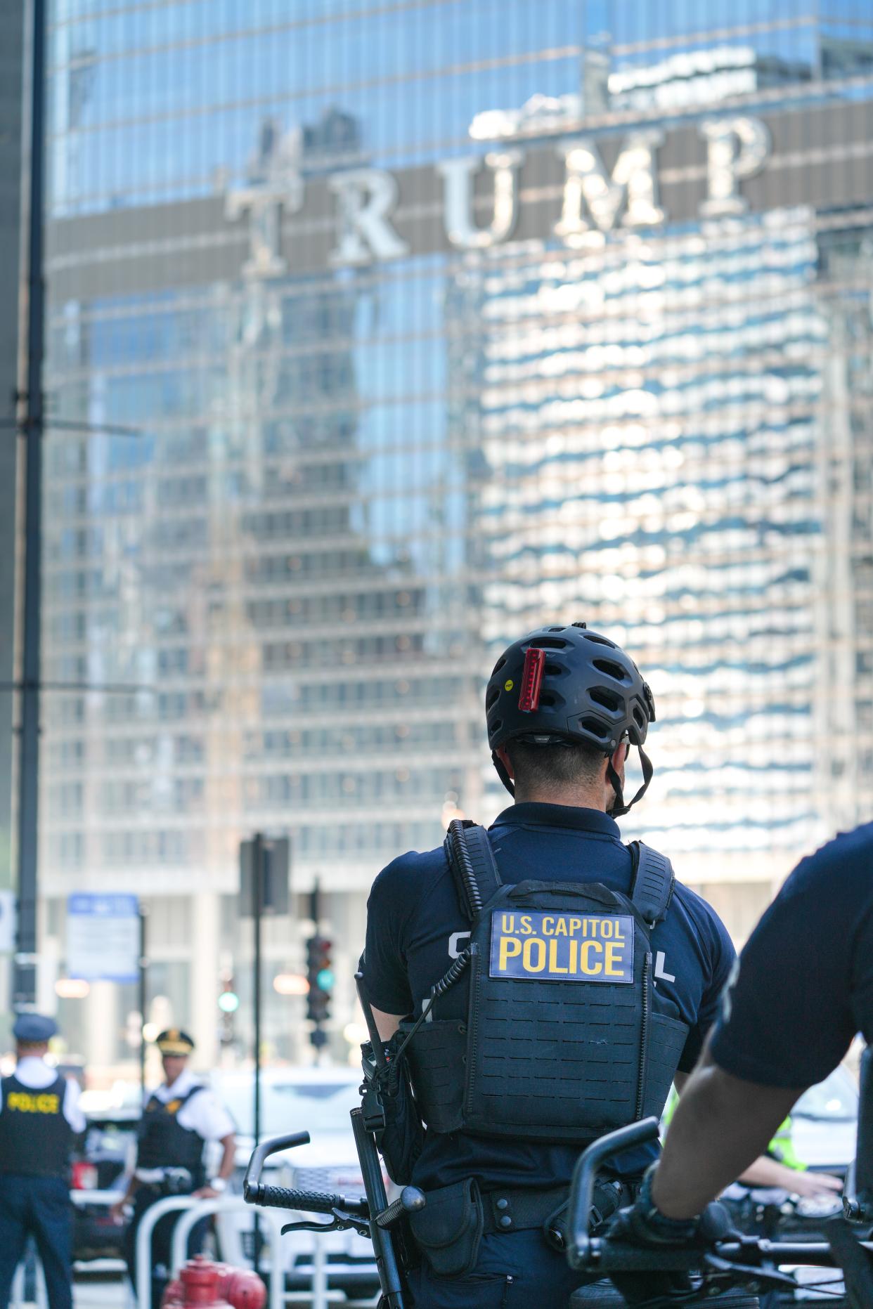 A US Capitol Police officer providing security at the Democratic National Convention in Chicago waits for a protest march to assemble near the Trump building in downtown Chicago.