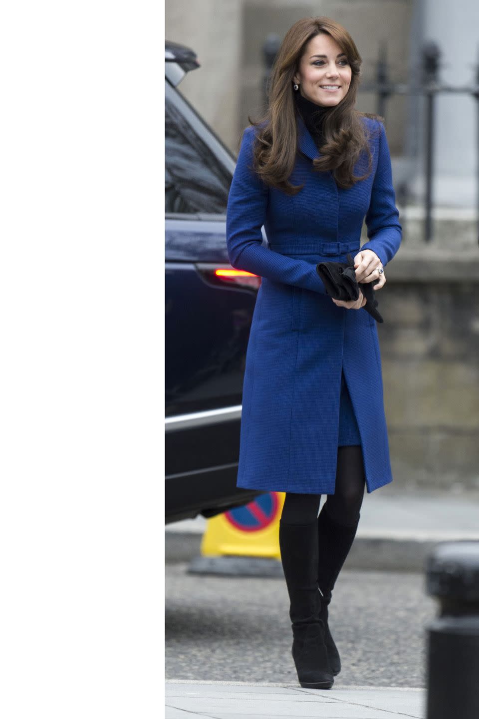 <p>In this turtleneck-layered look, the Duchess wore a royal blue Christopher Kane coat and black suede knee-high boots on her trip to Dundee, Scotland. </p>