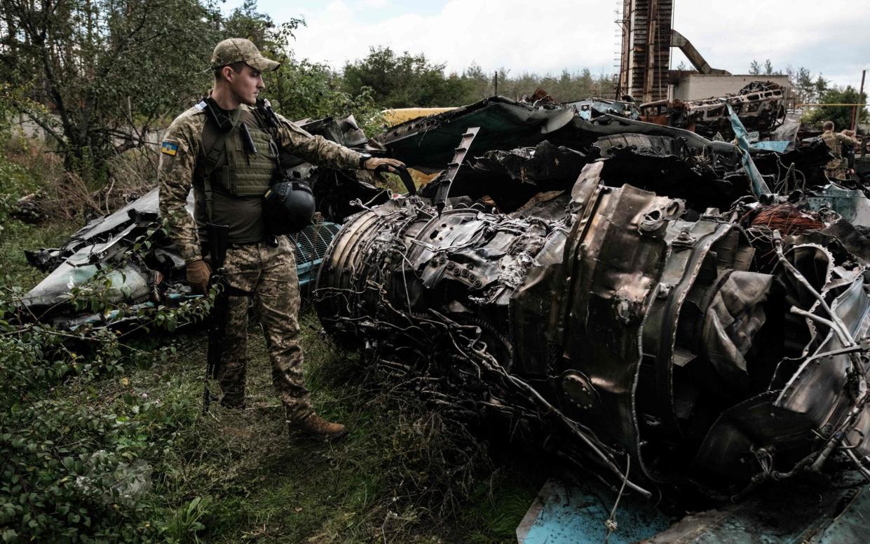 A Ukrainian soldier surveys destroyed Russian armoured vehicles at the recently retaken town of Lyman, in Dontesk - Yasuyoshi Chiba/AFP via Getty Images