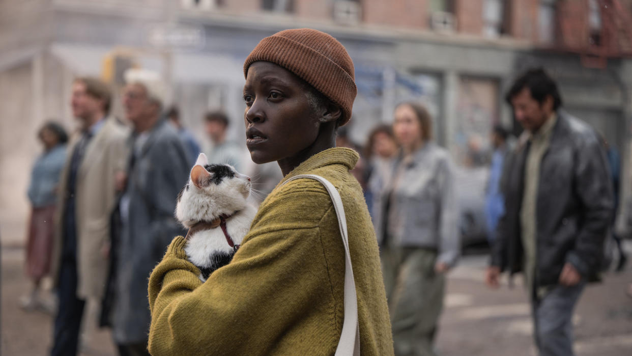  Lupita Nyong'o holding a cat in A Quiet Place: Day One. 