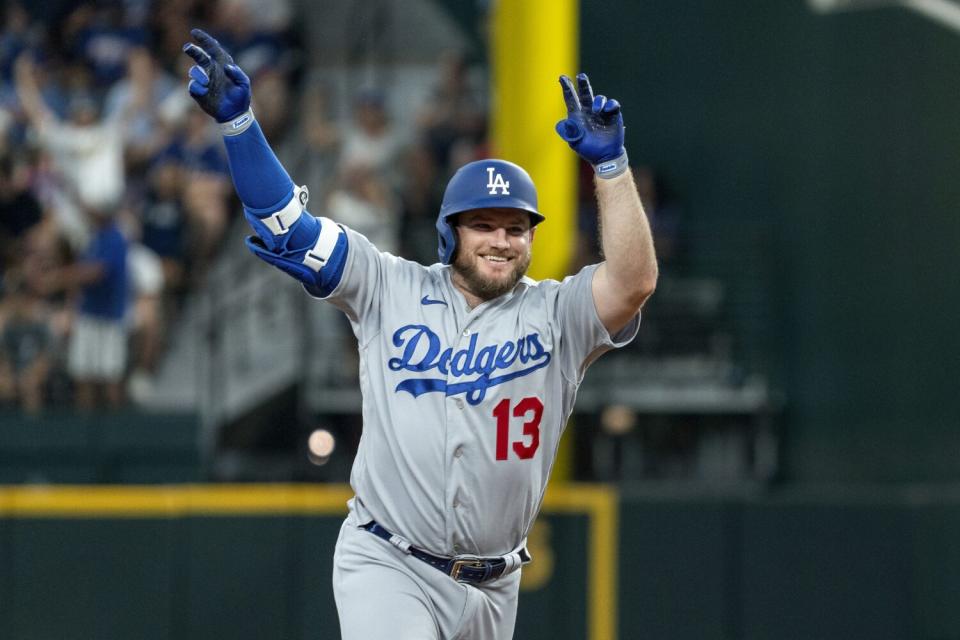 Max Muncy celebrates after hitting a solo home run in the third inning against the Rangers on Saturday.