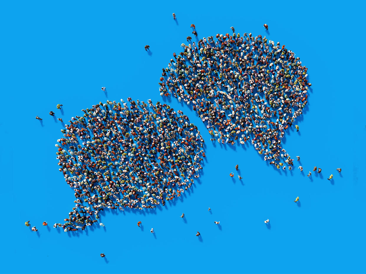 Human crowd forming a big speech bubble on blue background. Horizontal composition with copy space. Clipping path is included. Communication And Social Media Concept. (Photo: MicroStockHub via Getty Images)
