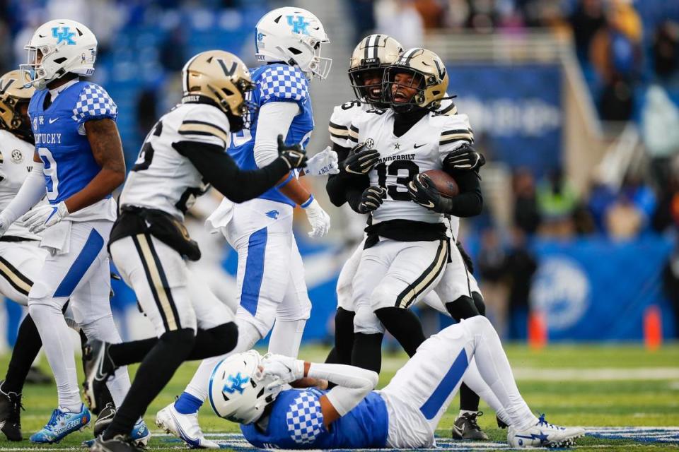 Vanderbilt standout CJ Taylor (13) celebrated after helping the Commodores upset Kentucky 24-21 last season at Kroger Field.