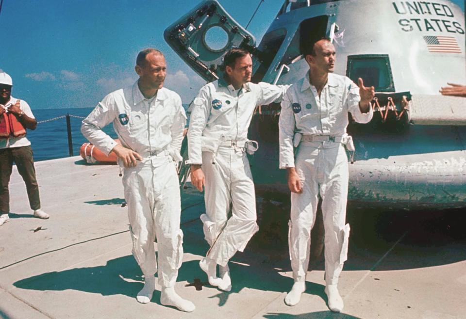 Buzz Aldrin, Neil Armstrong and Michael Collins stand next to their spacecraft in 1969 (AP)