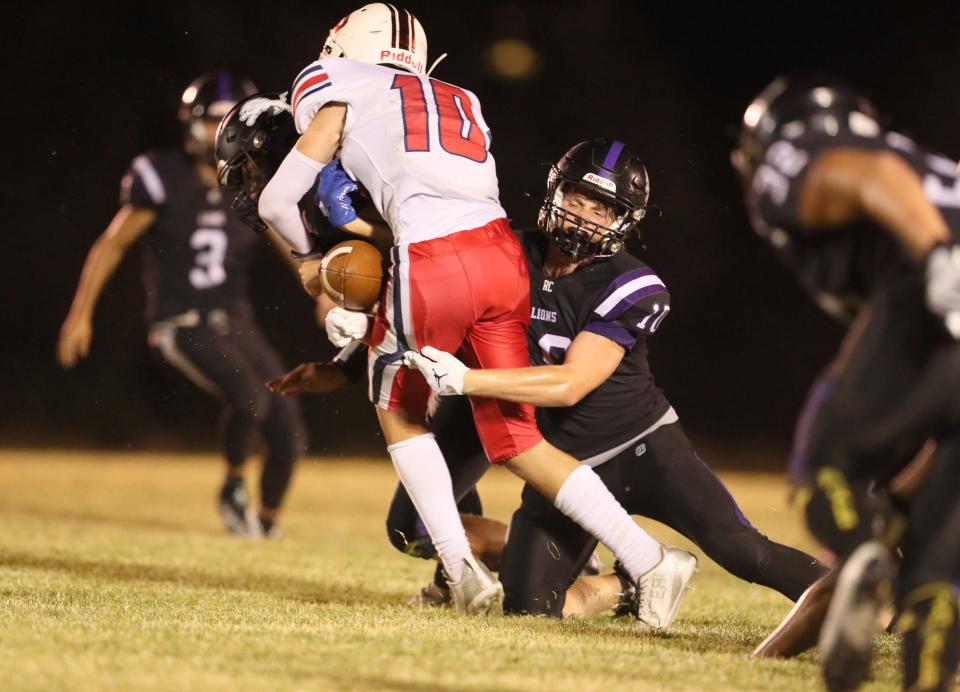 Redding Christian’s Gavin Webb (right) tries to stop Vacaville Christian’s Dylan Eddings (center) in the 3rd quarter.