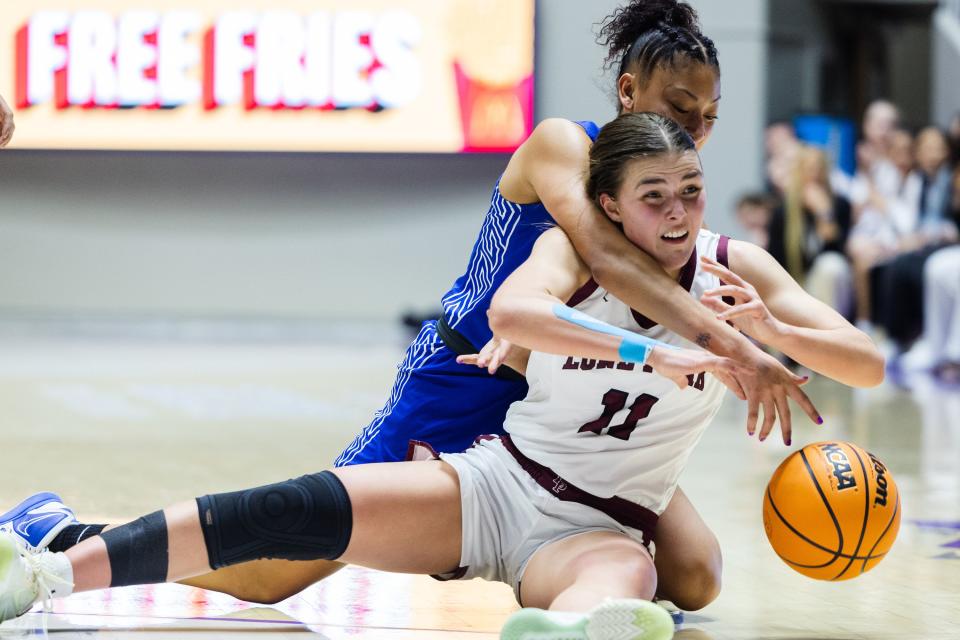 Lone Peak’s Kailey Woolston (11) wrestles for the ball during the 6A girls basketball state semifinals at the Dee Events Center at Weber State in Ogden on March 2, 2023. | Ryan Sun, Deseret News