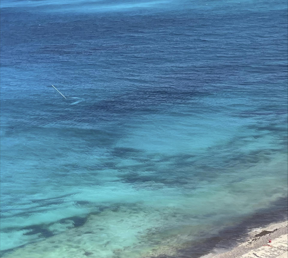 This photo provided by the U.S. Coast Guard shows a disabled sailboat during the Coast Guard's rescue on Friday, Aug. 18, 2023, of a 64-year-old man who spent three days stranded on an island in the Bahamas. Aircrews spotted flares being fired near the disabled sailboat. (U.S. Coast Guard via AP)