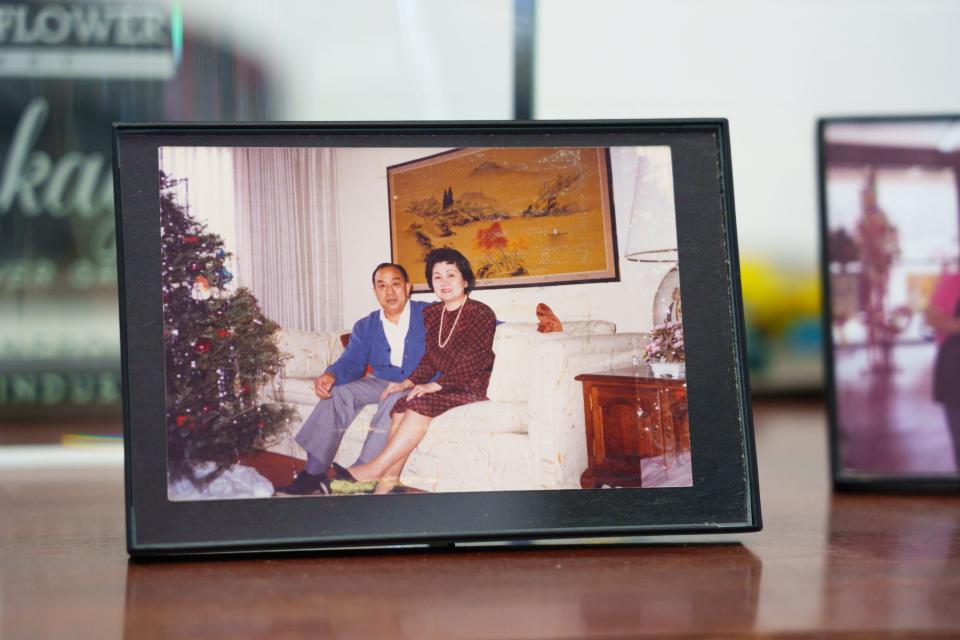 A picture of Baseline Flowers founder Hiroshi "Nick" Nakagawa, left, and wife, Tatsuko Nakagawa, sits on a desk at the flower shop on Sept. 30, 2022, in Phoenix, AZ. Baseline Flowers is now co-owned by their children.