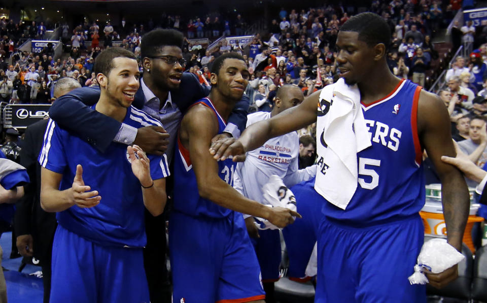 From left to right, Philadelphia 76ers' Michael Carter-Williams, Nerlens Noel, Hollis Thompson and Henry Sims celebrate in the final seconds of an NBA basketball game against the Detroit Pistons, Saturday, March 29, 2014, in Philadelphia. Philadelphia won 123-98, breaking a 26-game losing streak. (AP Photo/Matt Slocum)