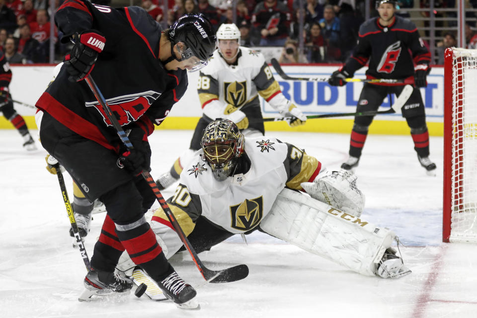 Carolina Hurricanes center Sebastian Aho is blocked by Vegas Golden Knights goaltender Malcolm Subban (30) during the second period of an NHL hockey game in Raleigh, N.C., Friday, Jan. 31, 2020. (AP Photo/Gerry Broome)