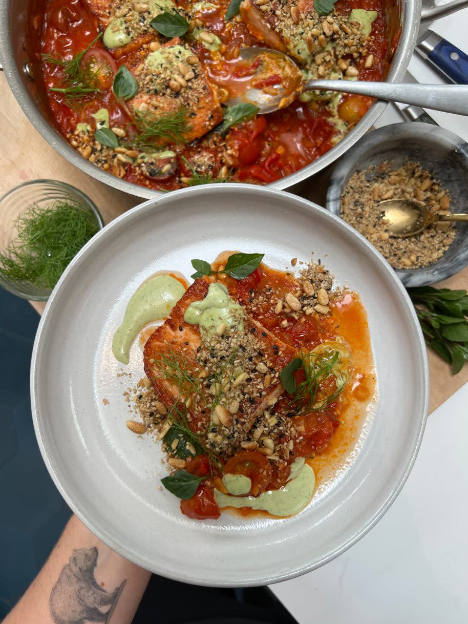 Williamson says this salmon, prepared with tomato and fennel soffritto, tahini sauce and pine nut dukkah, is a perfect summer fish recipe. (Photo: Brooke Williamson)