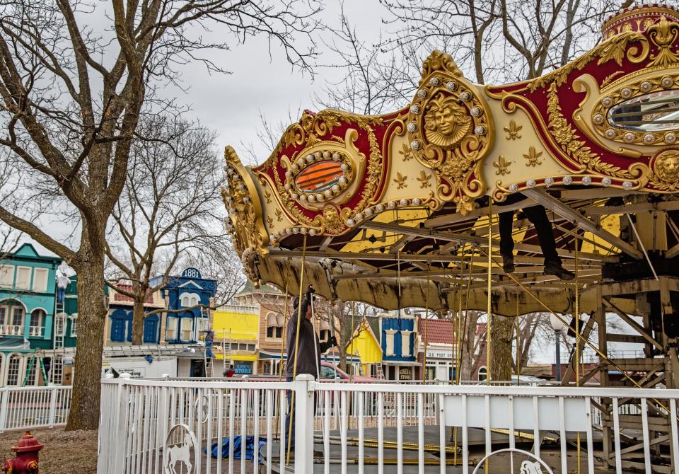 Workers rebuild the carousel at Adventureland in Altoona, Friday, April 15, 2022.