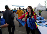 Boeing employee Alyssa Monserrate, hands out commemorative flags before the first flight of the new Boeing 787-10 Dreamliner at the Charleston International Airport in North Charleston, South Carolina, United States March 31, 2017. REUTERS/Randall Hill