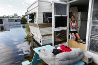 <p>Cherie Ethier sits in her mobile home with her pets surrounded by floodwater, in the Marco Naples RV Resort in the aftermath of Hurricane Irma, in Naples, Fla., Sept. 12, 2017. (Photo: Gerald Herbert/AP) </p>