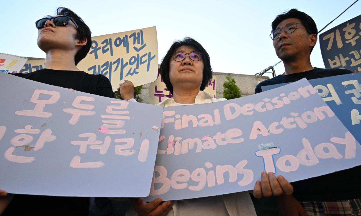 <span>South Korean climate campaigners outside the constitutional court in Seoul.</span><span>Photograph: Anthony Wallace/AFP/Getty Images</span>