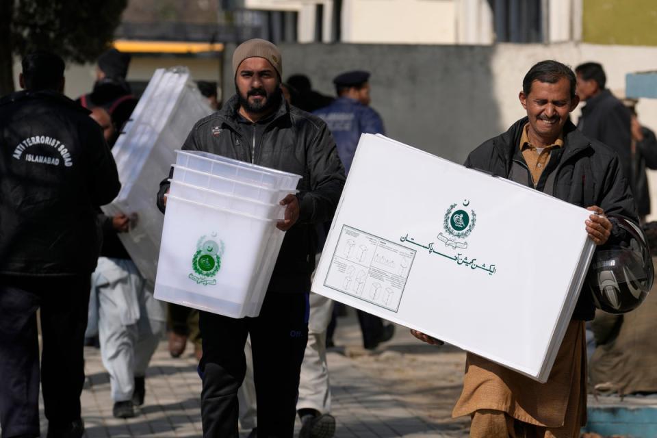 Polling staff leave after collecting polling material for Feb. 8 general elections at a collection point (AP)