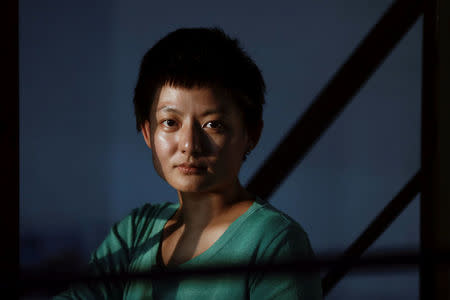 Chinese performance artist Yi Fei poses for a portrait at a friend's studio in the Songzhuang art colony outside Beijing, China, September 29, 2017. REUTERS/Thomas Peter