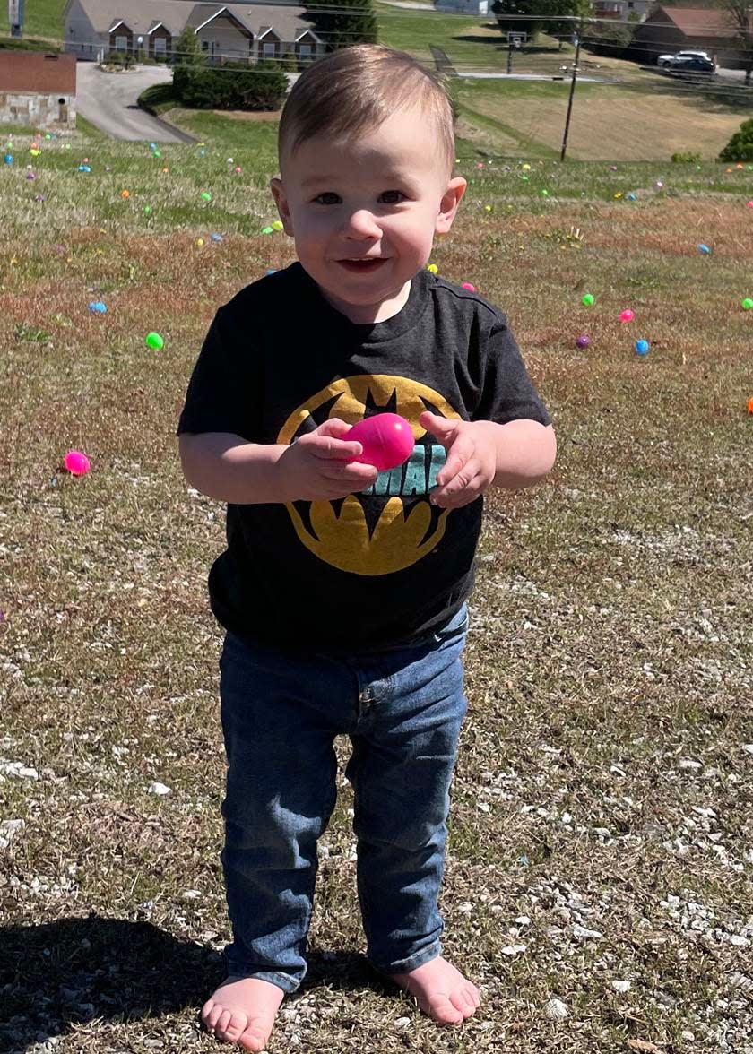 Ranen Brown, 1, collects an egg from the yard at the Easter Eggstravaganza at West Towne Christian Church, April 2, 2023.