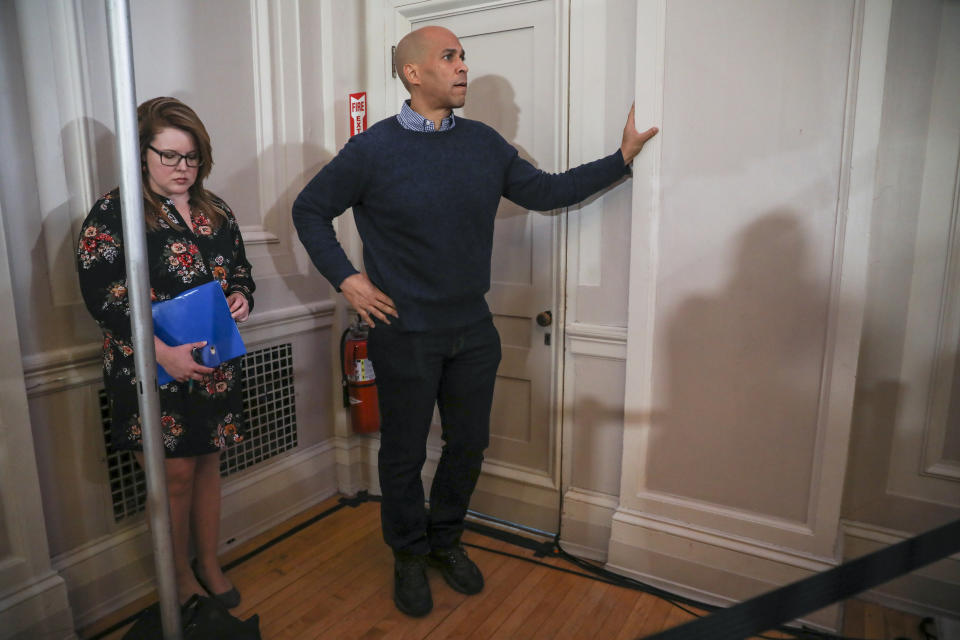 U.S. Sen. Cory Booker, D-N.J., waits on the sidelines for his turn to speak at a post-midterm election victory celebration in Manchester, N.H., on Saturday, Dec. 8, 2018. (AP Photo/Cheryl Senter)