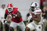 South Carolina running back Kevin Harris (20) carries the ball against Georgia during the first half of an NCAA college football game Saturday, Sept. 18, 2021, in Athens, Ga. (AP Photo/Butch Dill)