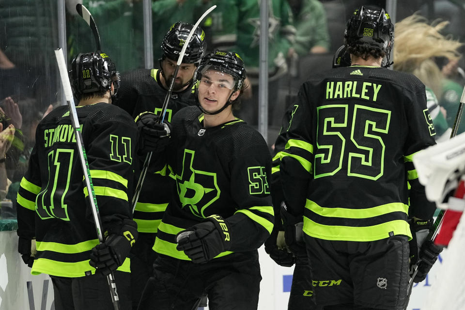Dallas Stars' Wyatt Johnston (53), Logan Stankoven (11), Thomas Harley (55) and Jamie Benn, center rear, celebrate Johnston's goal in the first period of an NHL hockey game against the New Jersey Devils in Dallas, Thursday, March 14, 2024. (AP Photo/Tony Gutierrez)