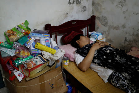 Chen Hong-zhi, 26, who suffers from short-term memory loss, sleeps in his bed in Hsinchu, Taiwan, September 26, 2018. REUTERS/Tyrone Siu