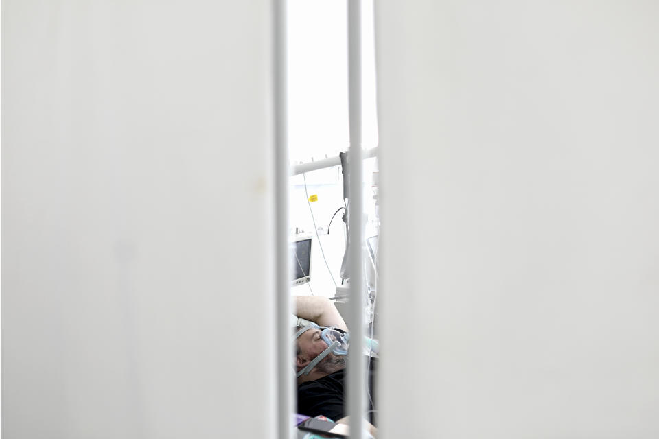 A patient lies on a bed at the COVID-19 ICU unit of the Dr. Abdulah Nakas General Hospital in Sarajevo, Bosnia, Friday, Sept. 24, 2021. Public mistrust of authorities in corruption-plagued Bosnia has created an opening for anti-vaccination movement even though the Balkan nation has the highest rate in Europe of coronavirus deaths and faces a growing number of new infections. So far, despite an abundance of coronavirus vaccines in Bosnia, just under 13 percent of its 3.3 million people had been fully immunized against Covid-19. (AP Photo)