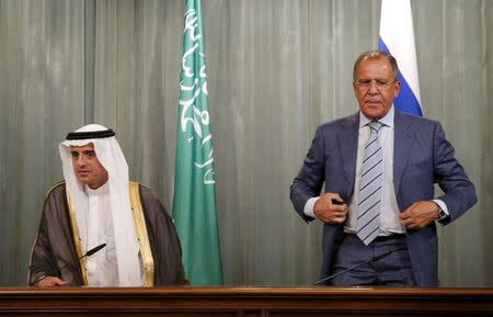 Russian Foreign Minister Sergei Lavrov (R) and Saudi Foreign Minister Adel al-Jubeir stand up as they attend a news conference after a meeting in Moscow, Russia, August 11, 2015. REUTERS/Maxim Shemetov