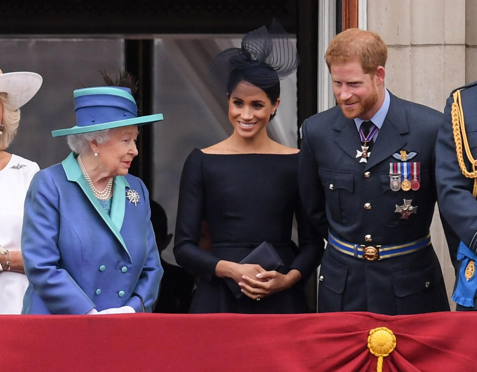 The Duke and Duchess of Sussex with the Queen at the RAF centenary celebrations. [Photo: Rex]