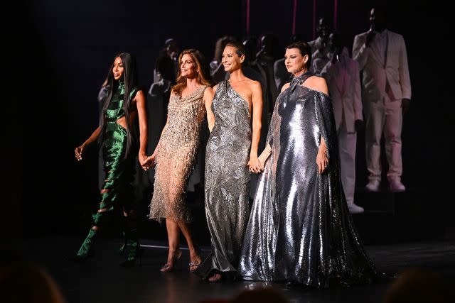 <p>Jeff Spicer/Getty</p> (L-R) Naomi Campbell, Cindy Crawford, Christy Turlington and Linda Evangelista walk hand in hand at Vogue World