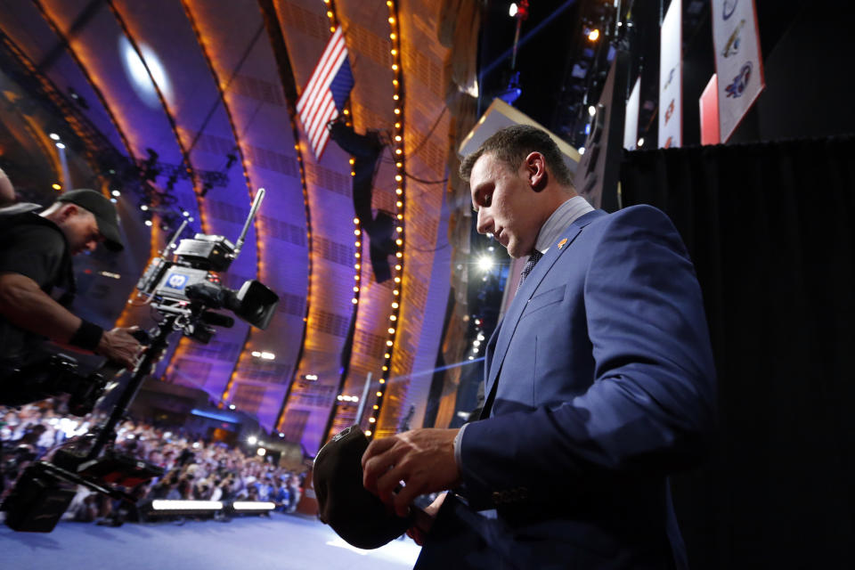 Johnny Manziel, from Texas A&M, walks onstage after being selected 22nd overall by the Cleveland Browns during the first round of the NFL football draft, Thursday, May 8, 2014, at Radio City Music Hall in New York. (AP Photo/Jason DeCrow)