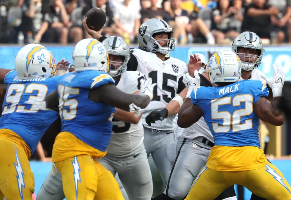 Chargers defenders pressure Raiders quarterback Gardner Minshew II (15) in the second half.