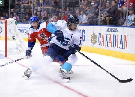 Sep 19, 2016; Toronto, Ontario, Canada; Team Europe forward Anze Kopitar (11) cuts away from the checking efforts of Czech Republic forward Tomas Plekanec (14 during the first period of their preliminary round game in the 2016 World Cup of Hockey at Air Canada Centre. Mandatory Credit: Dan Hamilton-USA TODAY Sports