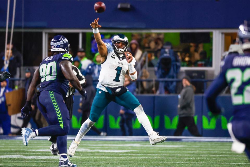 Dec 18, 2023; Seattle, Washington, USA; Philadelphia Eagles quarterback Jalen Hurts (1) passes against the Seattle Seahawks during the fourth quarter at Lumen Field. Mandatory Credit: Joe Nicholson-USA TODAY Sports