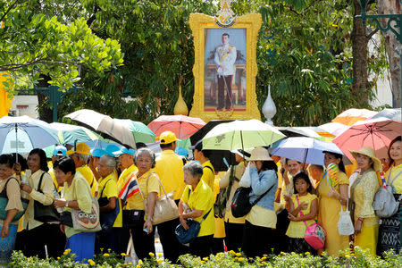 People stand in line to pass through a security check before attending a coronation procession for Thailand's newly crowned King Maha Vajiralongkorn near the Grand Palace in Bangkok, Thailand May 5, 2019. REUTERS/Jorge Silva