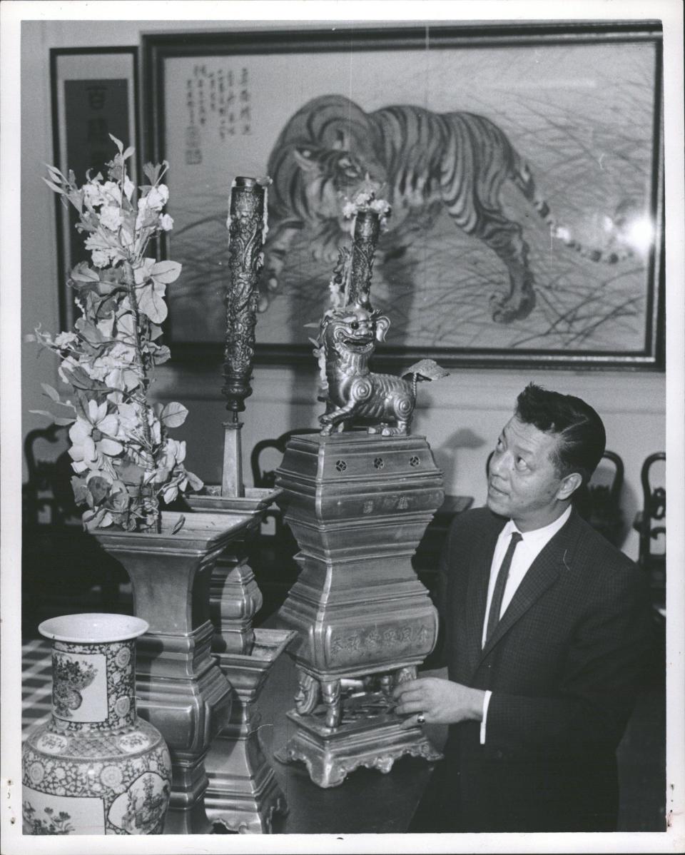 Chinatown "mayor" Henry Yee arranges a ceremonial altar for a meeting of On Leong, the Chinese Merchants Association, on Oct. 24, 1963. The group planned to give the tiger painting will be given to Detroit Tigers if they won a pennant.