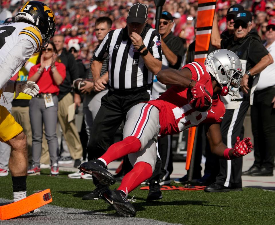 Ohio State wide receiver Marvin Harrison Jr. falls into the end zone for a touchdown against Iowa Saturday.