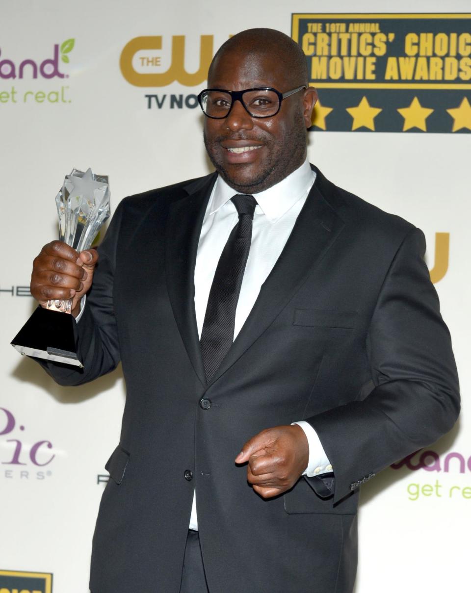 Steve McQueen poses in the press room with the award for best picture for "12 Years a Slave" at the 19th annual Critics' Choice Movie Awards at the Barker Hangar on Thursday, Jan. 16, 2014, in Santa Monica, Calif. (Photo by John Shearer/Invision/AP)