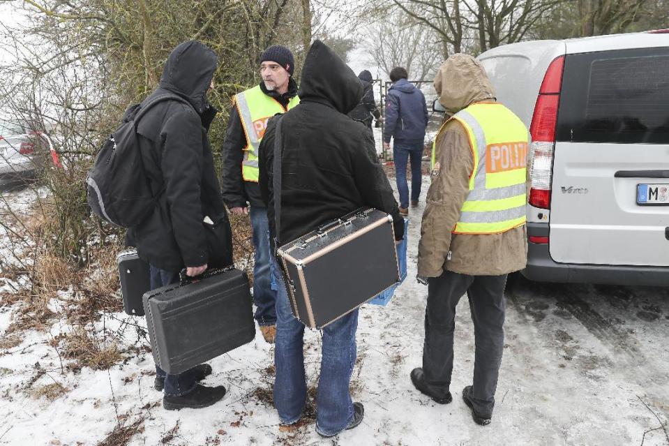 FILE - In this Jan. 30, 2017 file photo police officers and forensics walk towards the private premises where the bodies of six teenagers were found near Arnstein, Germany. German investigators said six teenagers who died of carbon monoxide poisoning at a garden house in Bavaria had been using a gasoline-powered generator that wasn't authorized for indoor use. On Thursday, Feb. 2, 2017 Wuerzburg prosecutors and police said they had pinned down the generator as the source of the gas. (Daniel Karmann/dpa via AP,file)